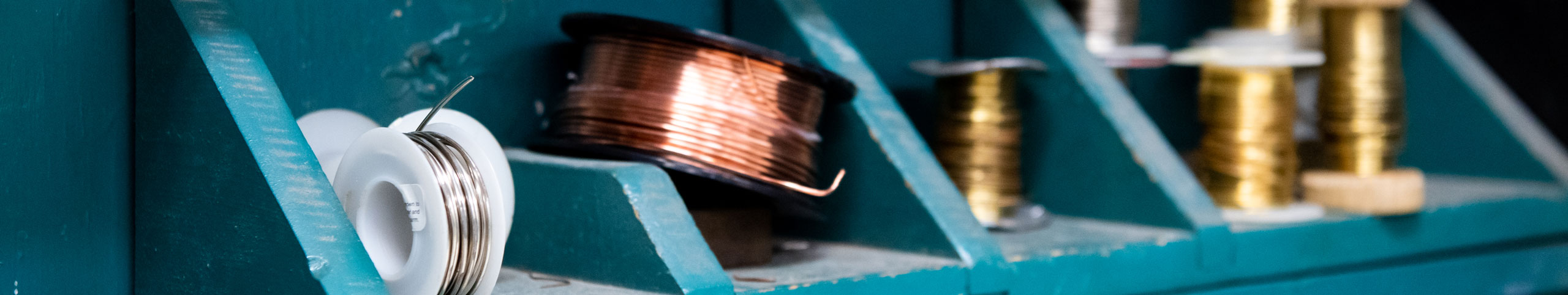 Rolls of metal wires used for jewelry making.