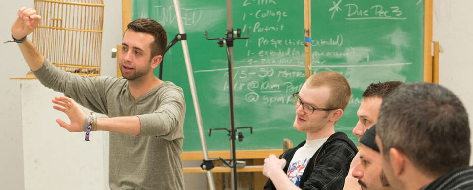 Masters students discuss art together.