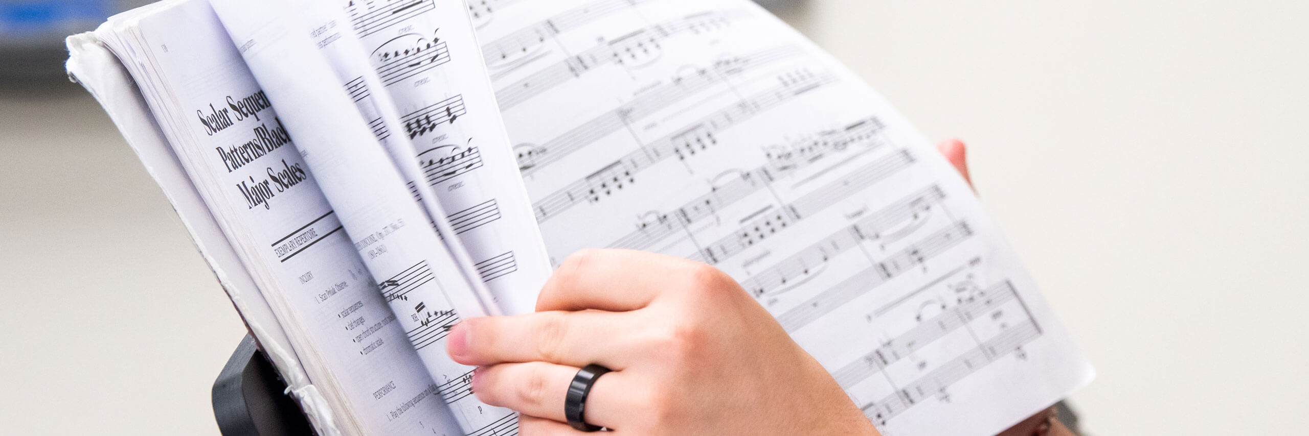 Student flips through their sheet music.