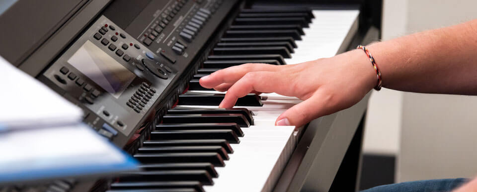 Student plays the keyboard.