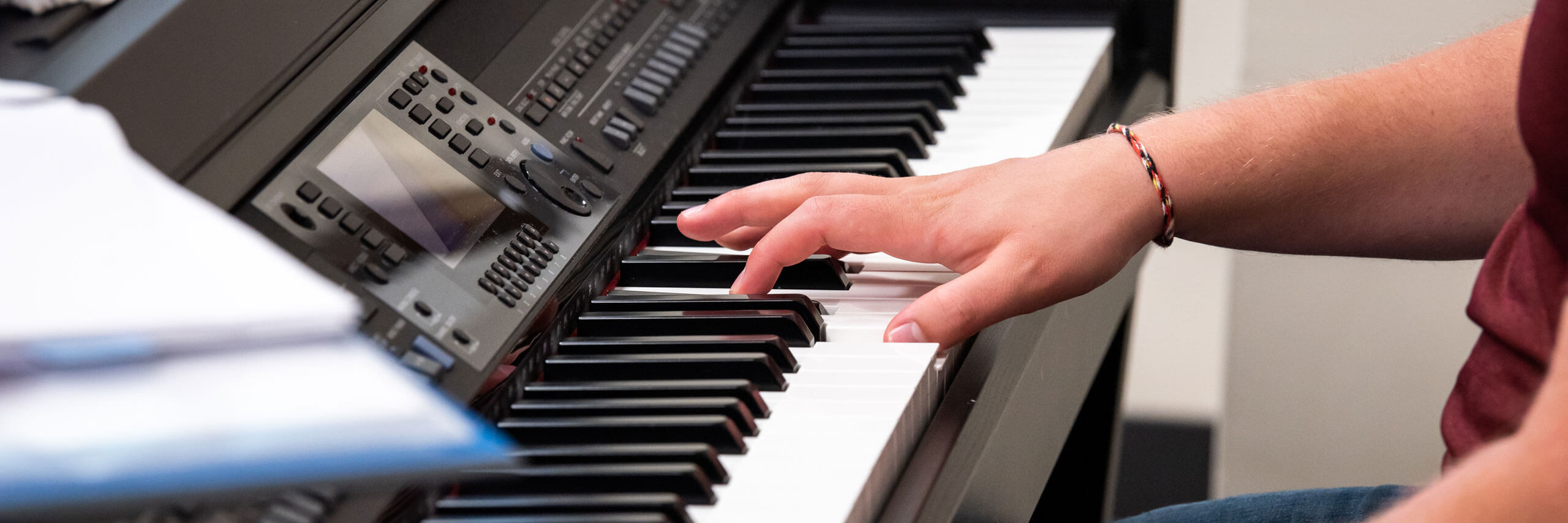 Student plays the keyboard.