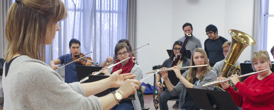 A director conducts her band.