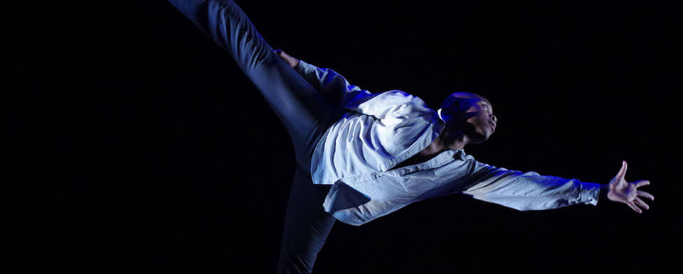 A dancer stretches into a pose.