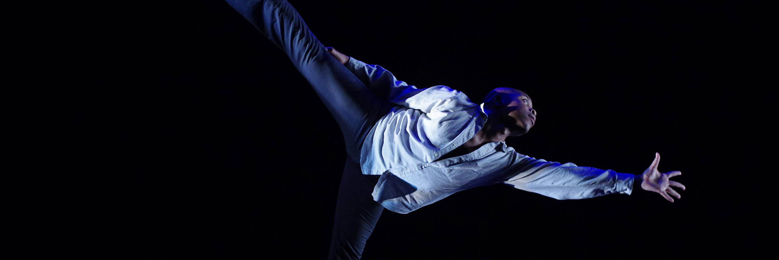 A dancer stretches into a pose.