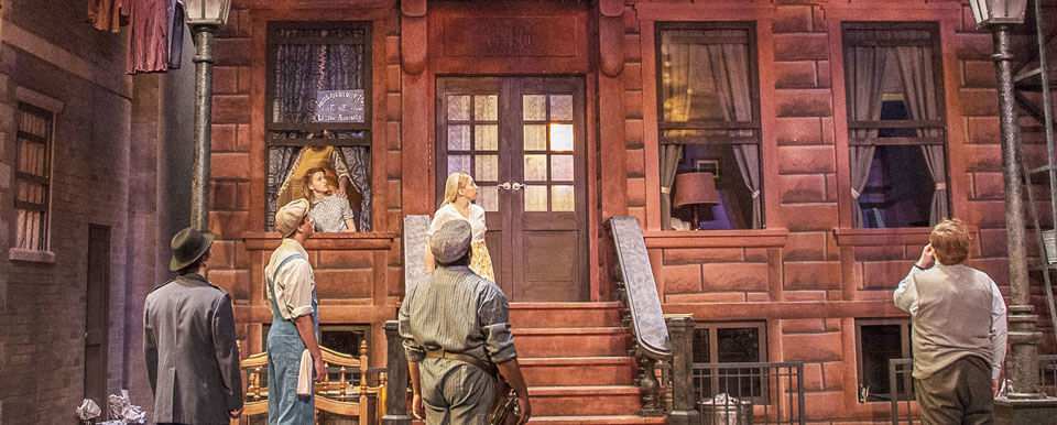 A scene of a production taking place on a street outside a home.