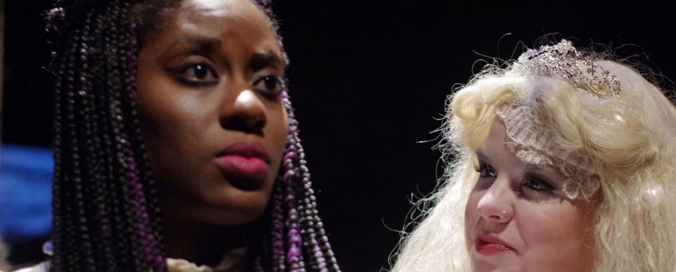 A close up of two actresses during a production.