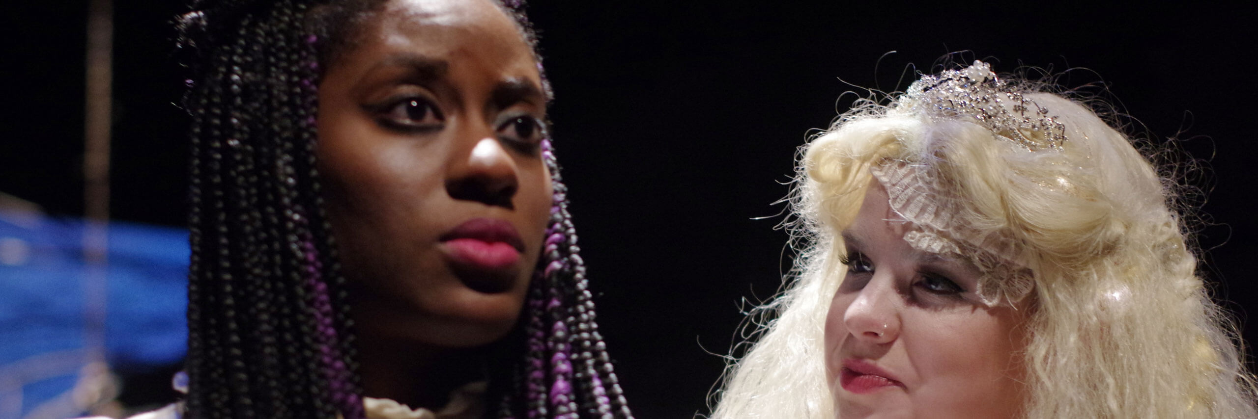 A close up of two actresses during a production.