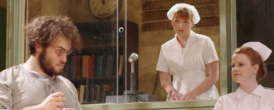 An actor and two actresses play a patient and two nurses in a theatre production.