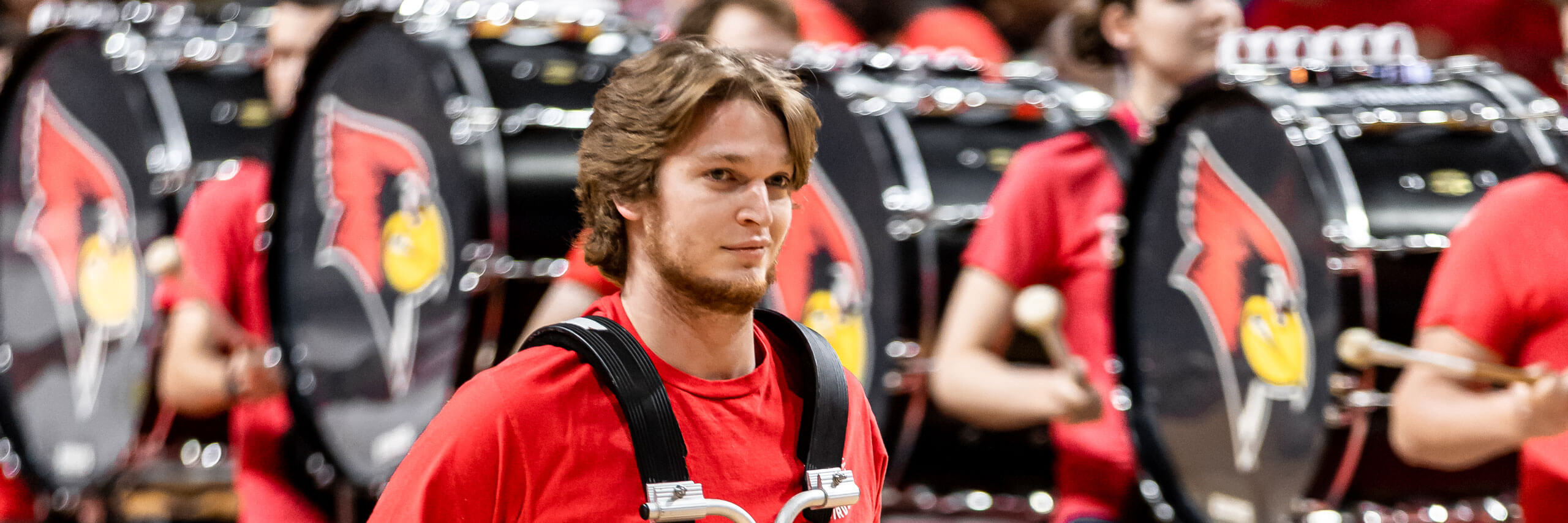 The Basketball drumline performs on the court.