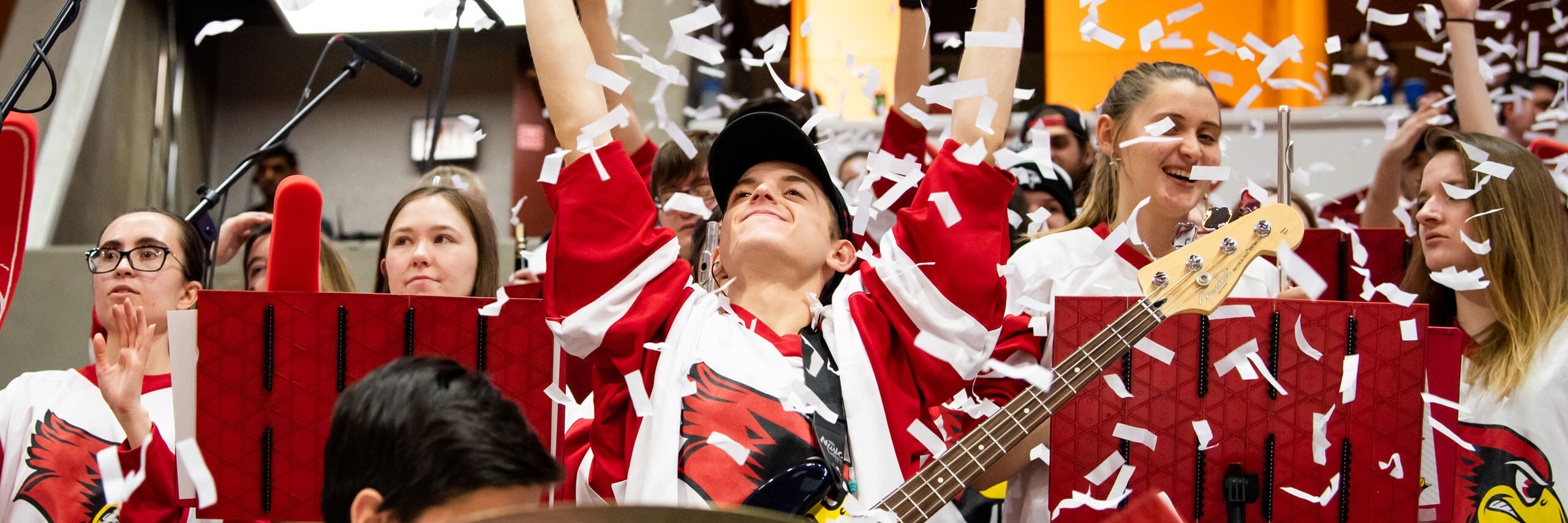 The pep band cheers in the stands.