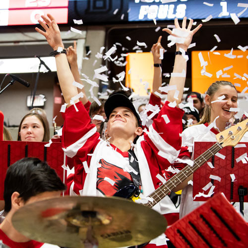 The pep band cheers in the stands.