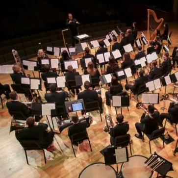 A band with a director conducting.