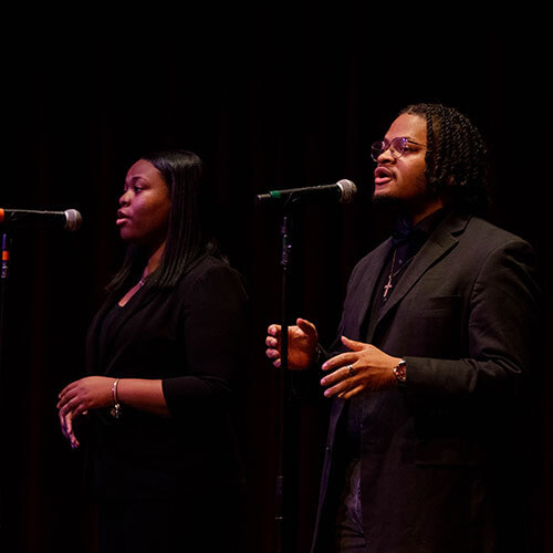 The Interdenominational Youth Choir sings acapella on stage.