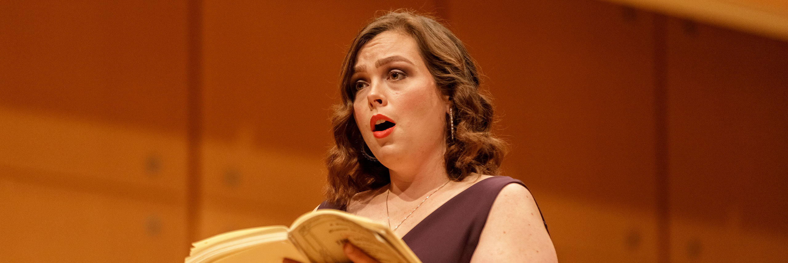 Student sings a solo at a choir concert.