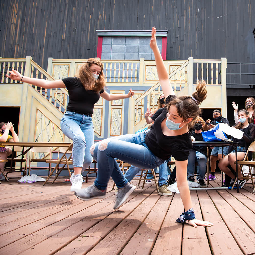 students performing on stage