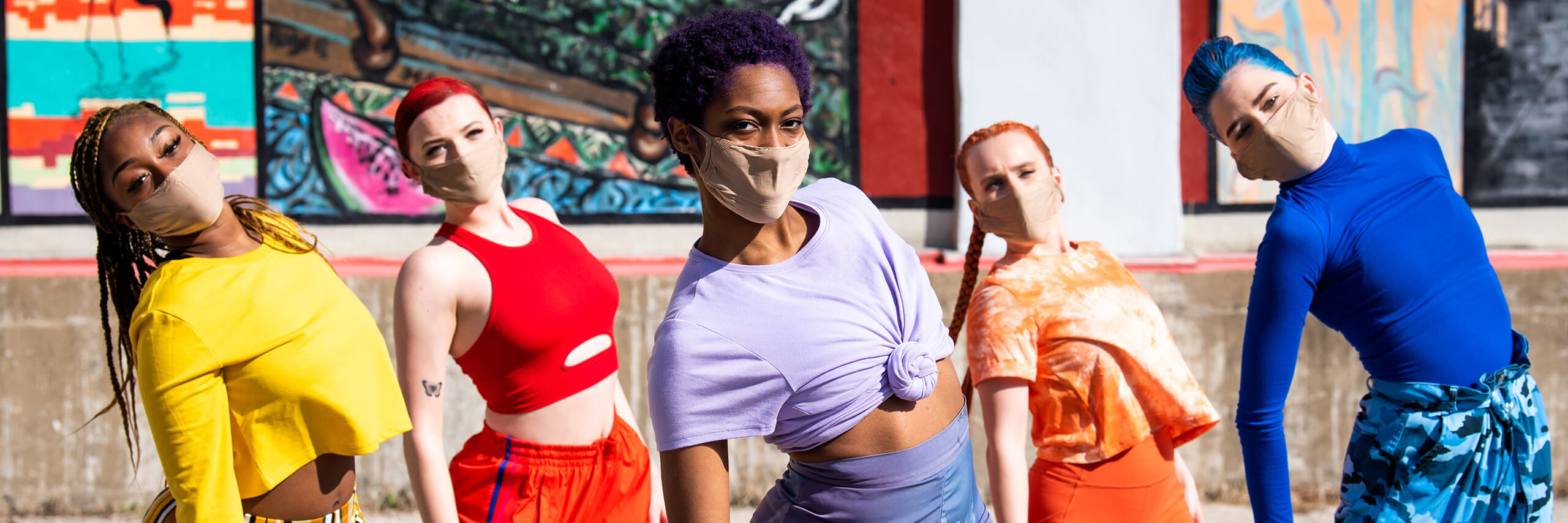 Group of five dancers each in their own colorful costume.