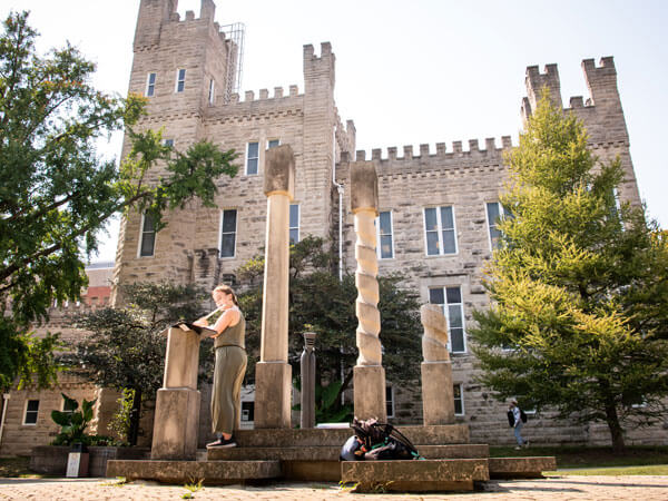 Student plays her flute outside of Cook Hall.