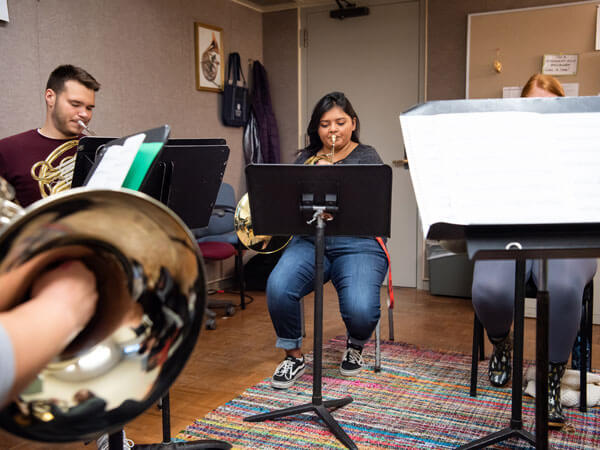 A french horn ensemble rehearses.