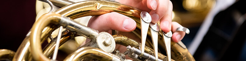 Student holding musical instrument