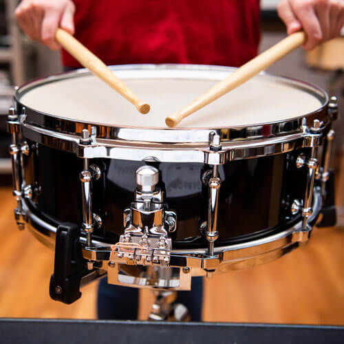 Student plays the snare drum.