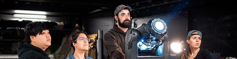 Students studying stage lighting